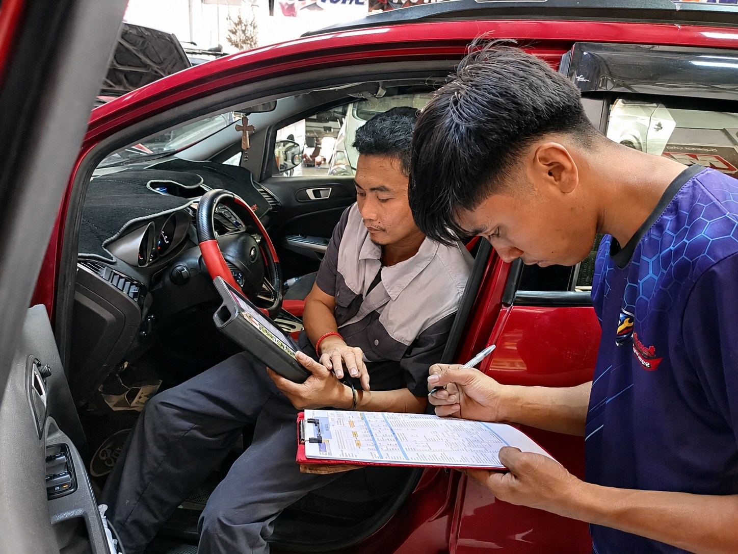Northeast Car Care Centre technicians performing a vehicle inspection